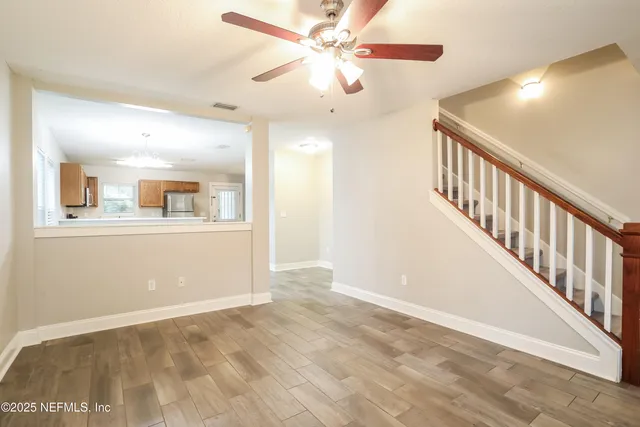 a view of a livingroom with a ceiling fan and entryway