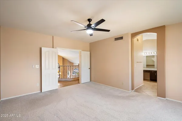 a view of a livingroom with a window and a ceiling fan