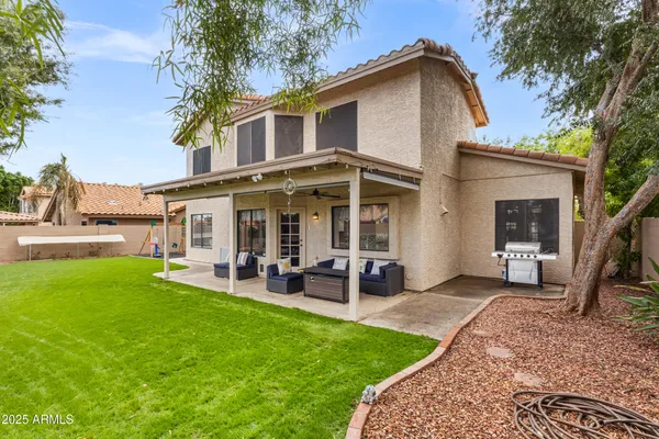 a view of a house with a yard and sitting area