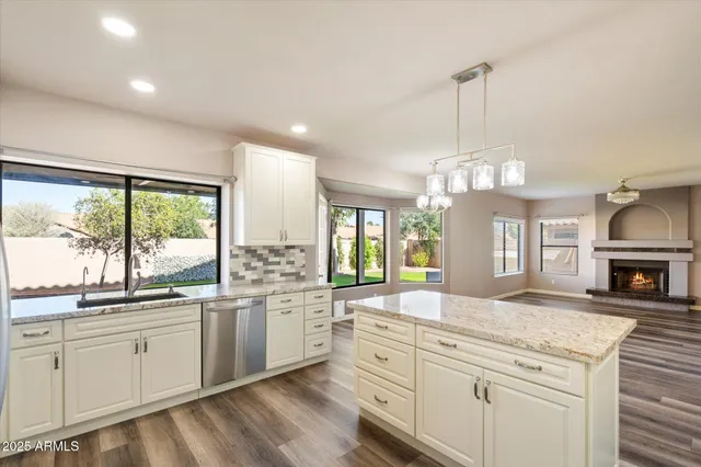 a view of a livingroom with a window and a ceiling fan