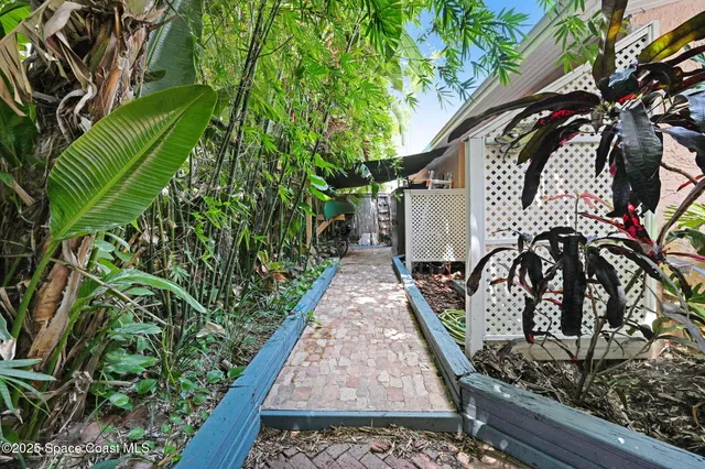 a living room with furniture a flat screen tv and floor to ceiling window