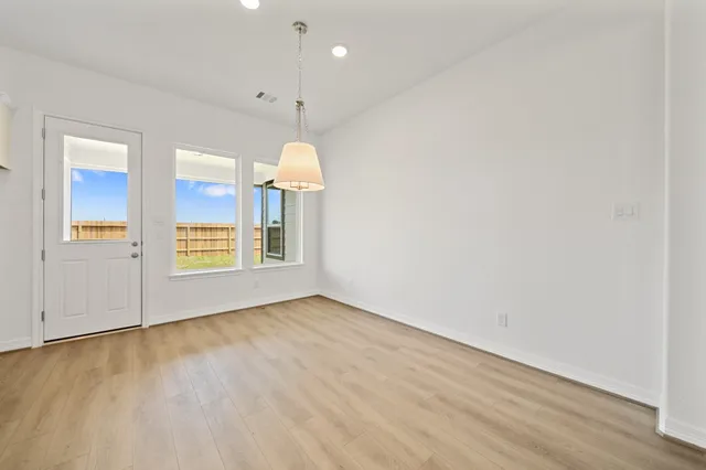 a living room with furniture kitchen view and a large window