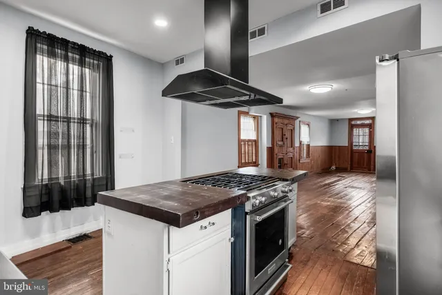 a kitchen with a stove and a refrigerator