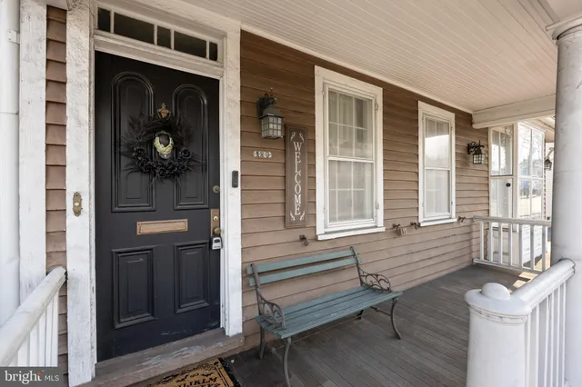 a view of front door of house with stairs