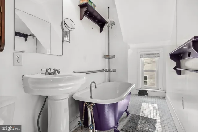 a bathroom with a sink a toilet and bathtub