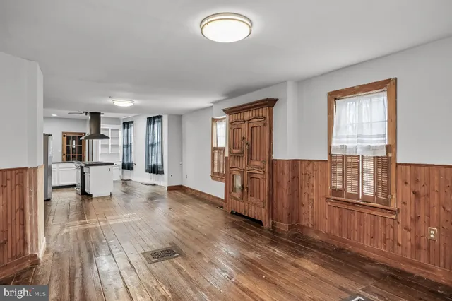 a view of a kitchen with wooden floor and a kitchen