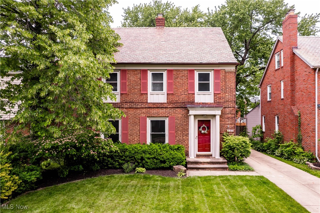 3845 Hillbrook Road Cleveland, OH 44118 - Photo 1 of 38 Colonial home featuring a front lawn, a chimney, brick siding, and a shingled roof