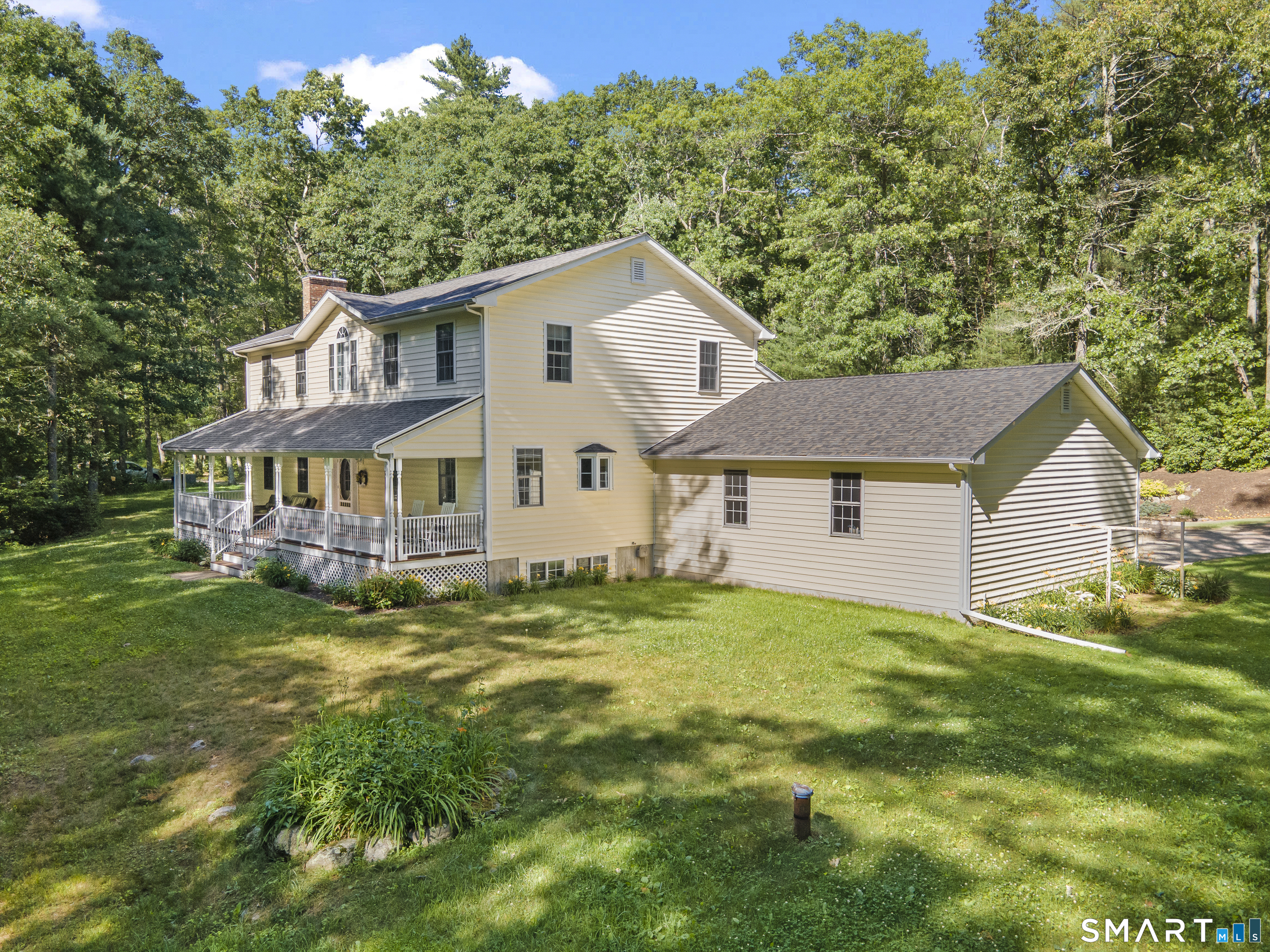 175 Cranberry Bog Road Killingly, CT 06239 - Photo 1 of 40 a house that is sitting in the grass with large trees and plants