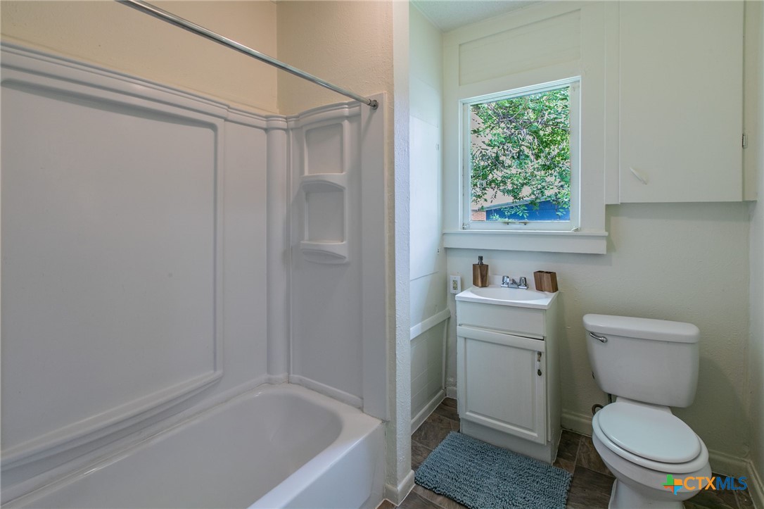 1303 South 15th Street Temple, TX 76504 - Photo 11 of 19 a bathroom with a toilet a sink and a bathtub
