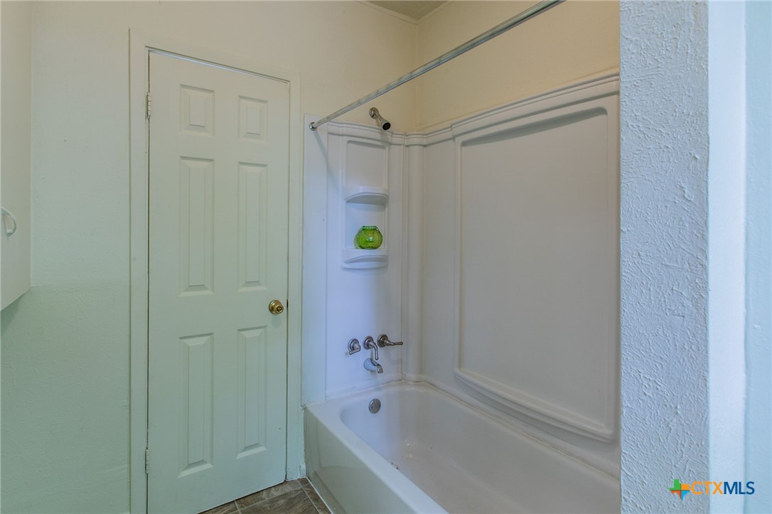 1303 South 15th Street Temple, TX 76504 - Photo 12 of 19 a bathroom with a shower and a bathtub