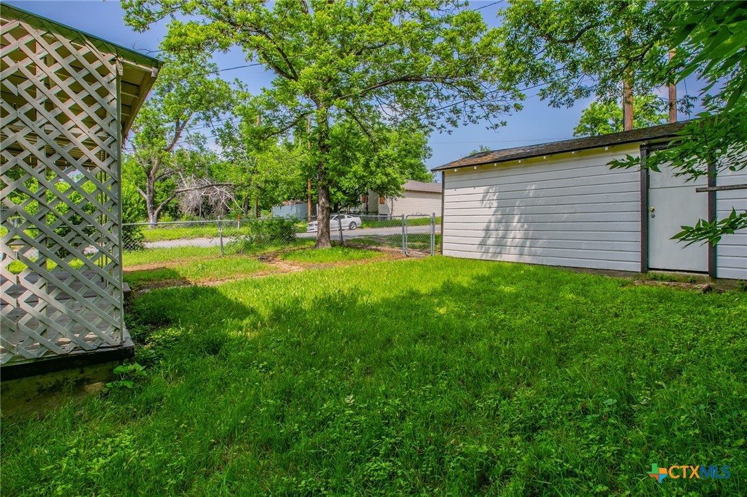 1303 South 15th Street Temple, TX 76504 - Photo 19 of 19 a view of a backyard with plants and large trees