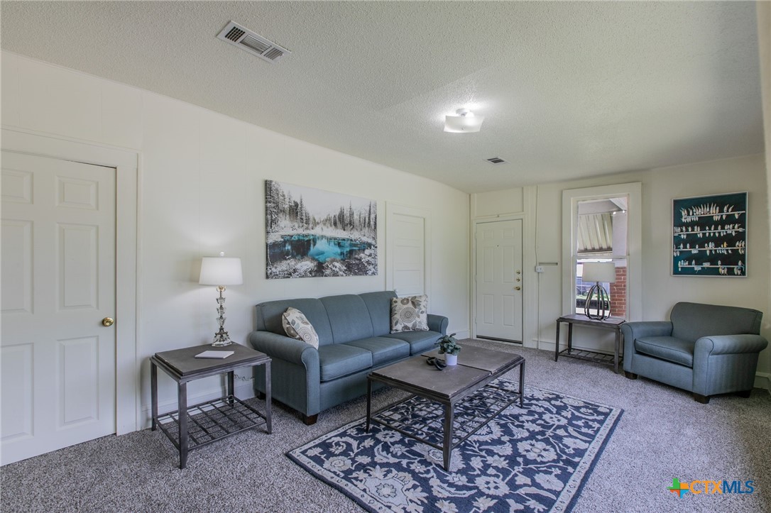1303 South 15th Street Temple, TX 76504 - Photo 2 of 19 a living room with furniture and a rug