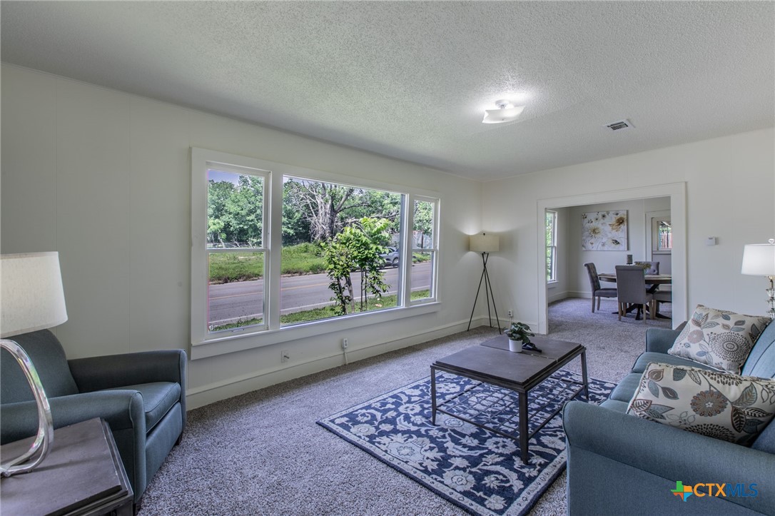 1303 South 15th Street Temple, TX 76504 - Photo 3 of 19 a living room with furniture and a large window