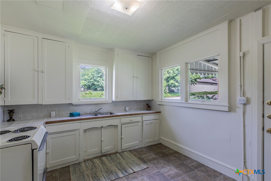 1303 South 15th Street Temple, TX 76504 - Photo 4 of 19 a kitchen with a sink cabinets and window