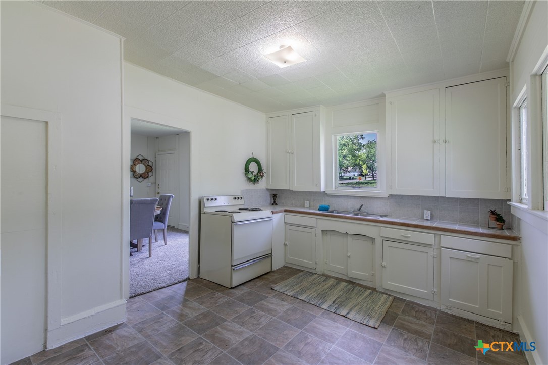 1303 South 15th Street Temple, TX 76504 - Photo 5 of 19 a kitchen with a sink and cabinets