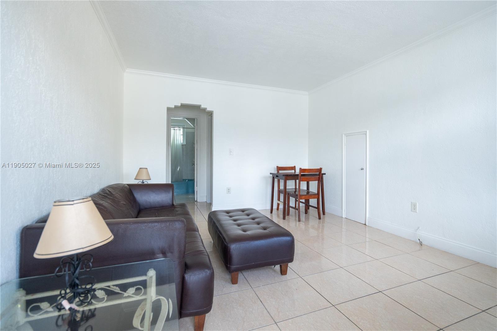 7435 Harding Avenue, Unit 204A Miami Beach, FL 33141 - Photo 3 of 14 a living room with furniture and two chairs