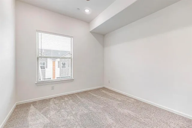 an empty room with closet and entryway