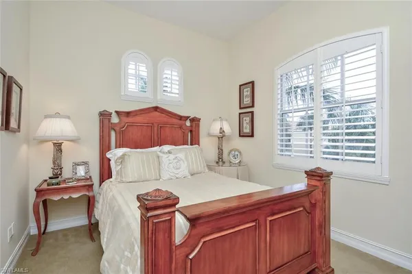 a bedroom with a bed and a lamp
