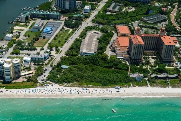an aerial view of a house with a yard and outdoor seating