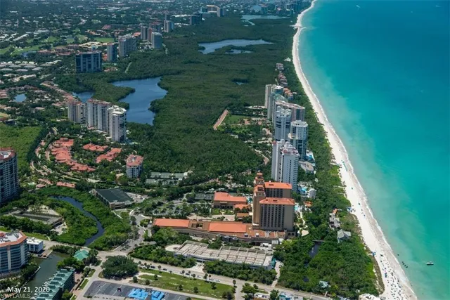 an aerial view of residential houses with outdoor space and trees