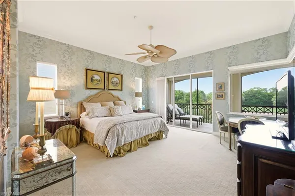 a spacious bedroom with a bed and a large window