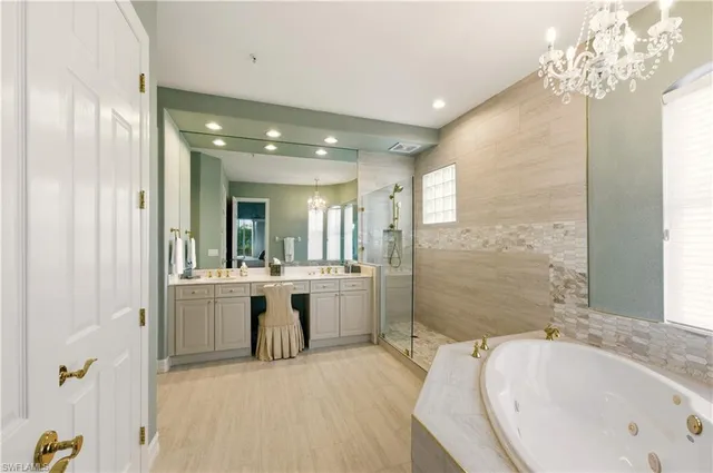 a bathroom with a tub sink shower and mirror