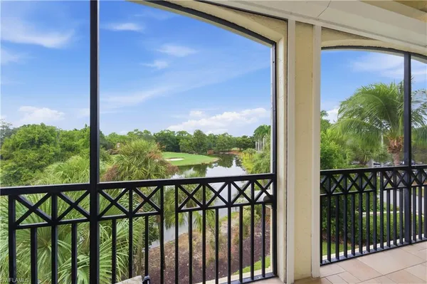 a view of a balcony with a floor to ceiling window next to a yard