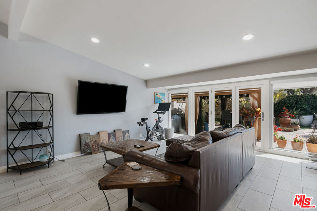 11332 Loch Lomond Road Los Alamitos, CA 90720 - Photo 11 of 55 a living room with furniture and a flat screen tv