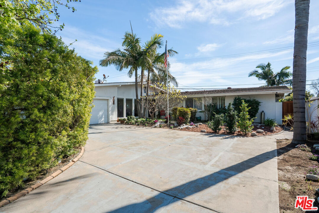 11332 Loch Lomond Road Los Alamitos, CA 90720 - Photo 2 of 55 front view of house with a bench and potted plants