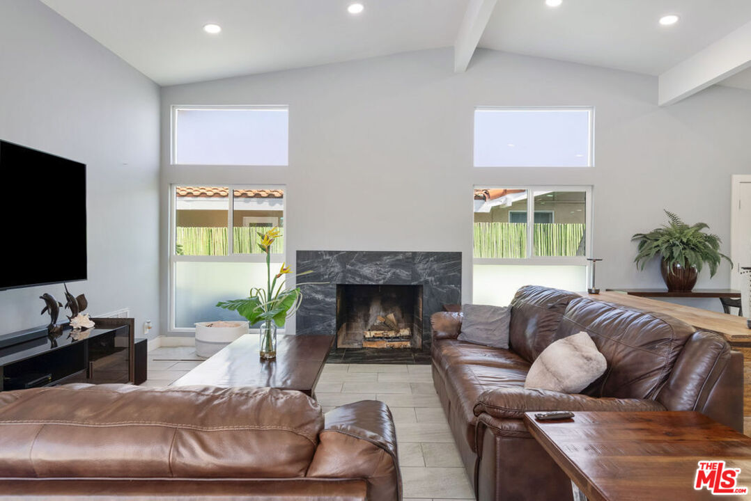11332 Loch Lomond Road Los Alamitos, CA 90720 - Photo 26 of 55 a living room with furniture fireplace and a flat screen tv