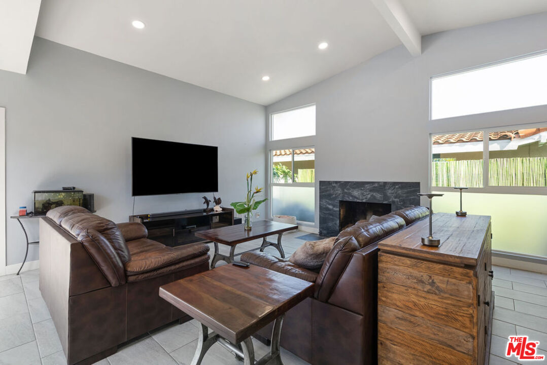 11332 Loch Lomond Road Los Alamitos, CA 90720 - Photo 28 of 55 a living room with furniture a flat screen tv and a large window