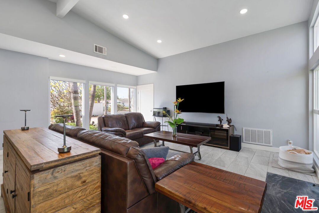 11332 Loch Lomond Road Los Alamitos, CA 90720 - Photo 29 of 55 a living room with furniture and a flat screen tv