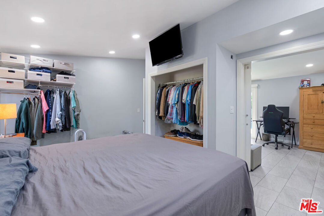 11332 Loch Lomond Road Los Alamitos, CA 90720 - Photo 31 of 55 a bedroom with a bed and a tv