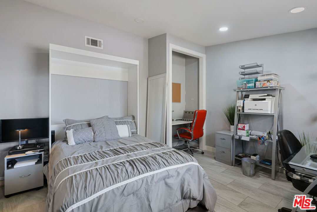 11332 Loch Lomond Road Los Alamitos, CA 90720 - Photo 32 of 55 a bedroom with a bed a desk and chair