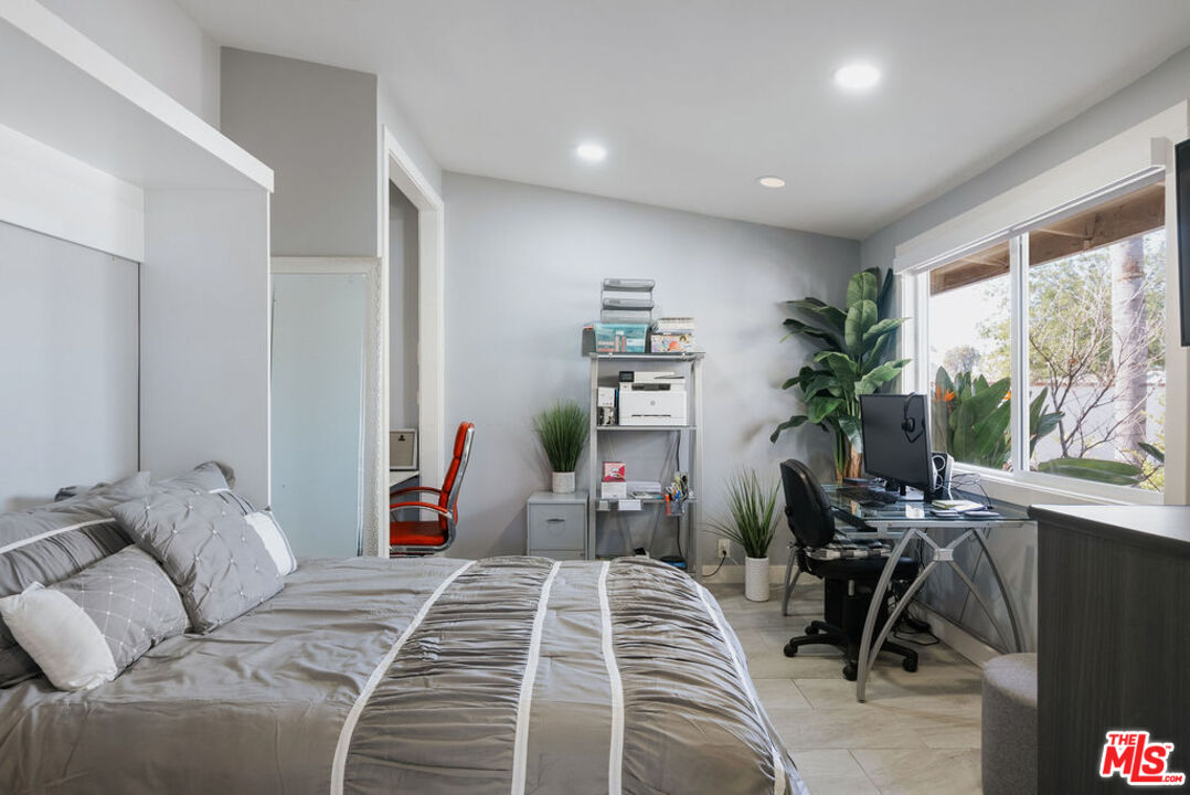 11332 Loch Lomond Road Los Alamitos, CA 90720 - Photo 33 of 55 a bedroom with furniture and a large window