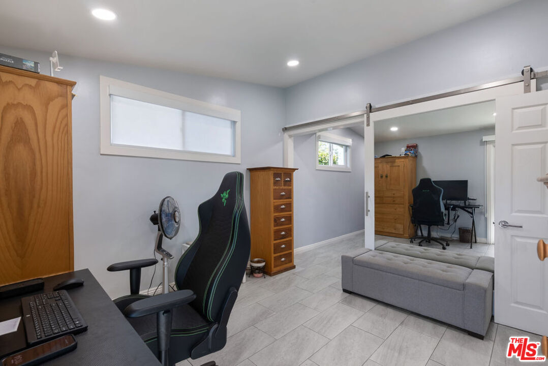 11332 Loch Lomond Road Los Alamitos, CA 90720 - Photo 37 of 55 a living room with furniture and a gym machine