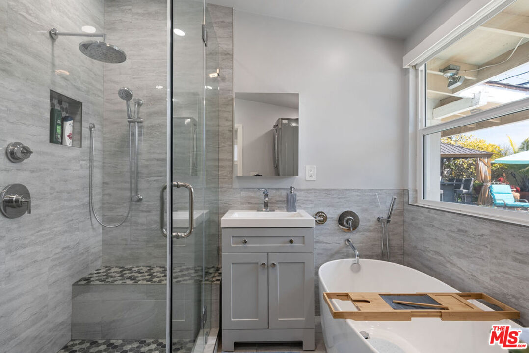 11332 Loch Lomond Road Los Alamitos, CA 90720 - Photo 39 of 55 a bathroom with a sink a toilet and shower