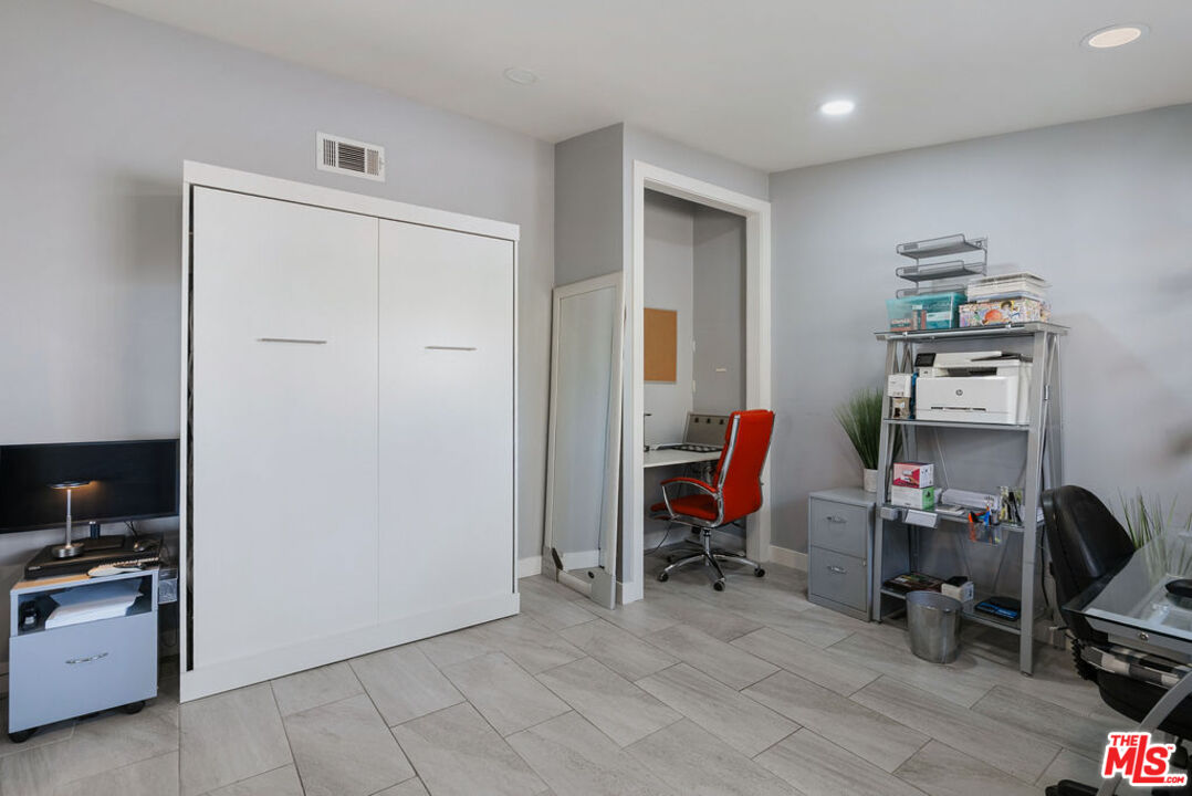 11332 Loch Lomond Road Los Alamitos, CA 90720 - Photo 42 of 55 a view of a workspace with furniture and wooden floor