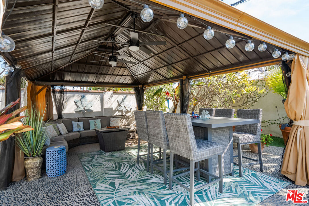 11332 Loch Lomond Road Los Alamitos, CA 90720 - Photo 44 of 55 a patio with glass top table and chairs