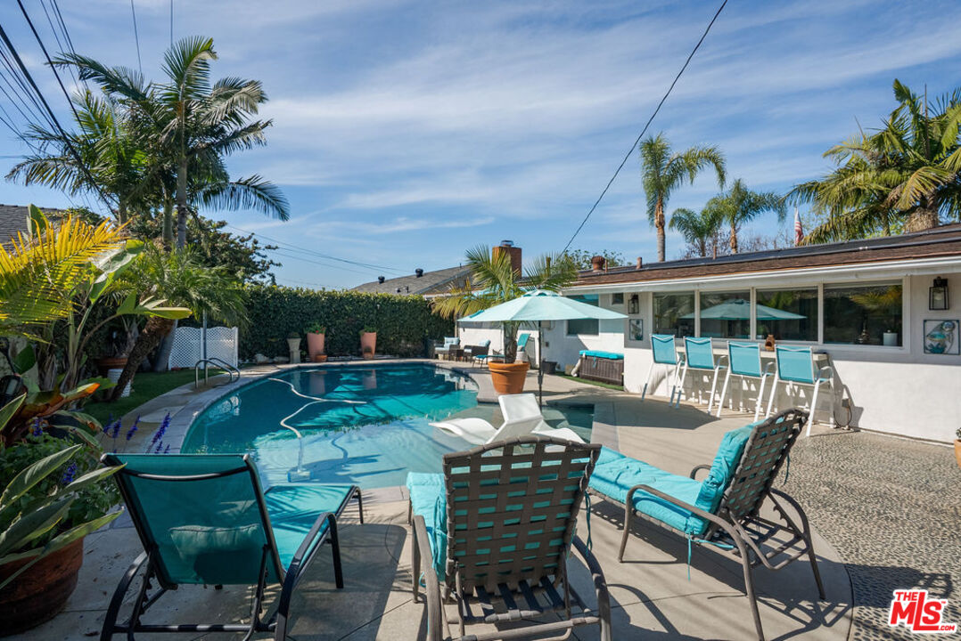 11332 Loch Lomond Road Los Alamitos, CA 90720 - Photo 48 of 55 a view of a patio with table and chairs potted plants with wooden floor