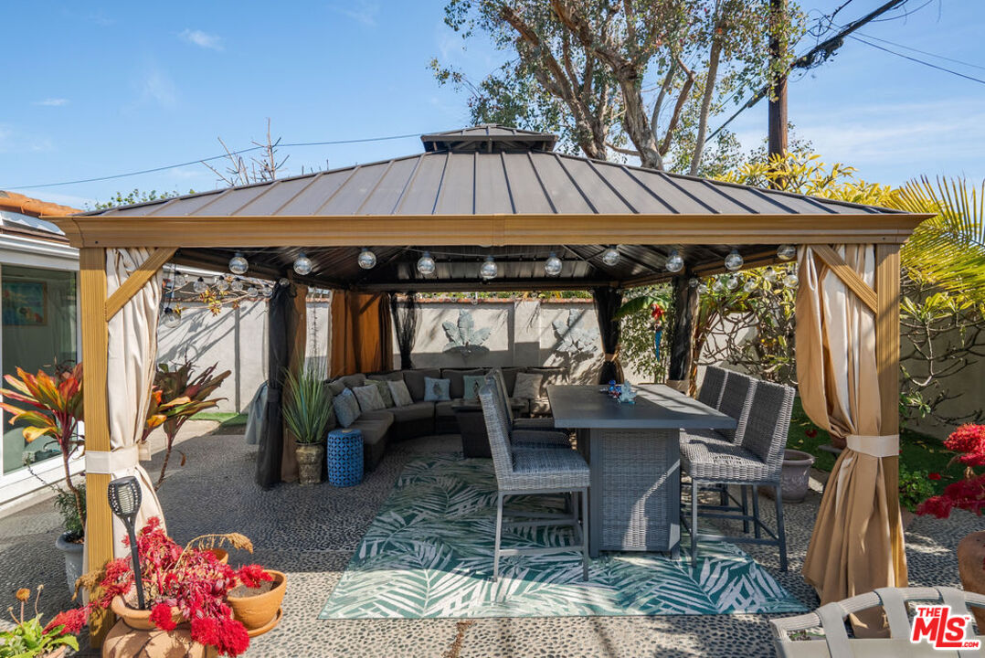 11332 Loch Lomond Road Los Alamitos, CA 90720 - Photo 54 of 55 a view of a patio with table and chairs potted plants