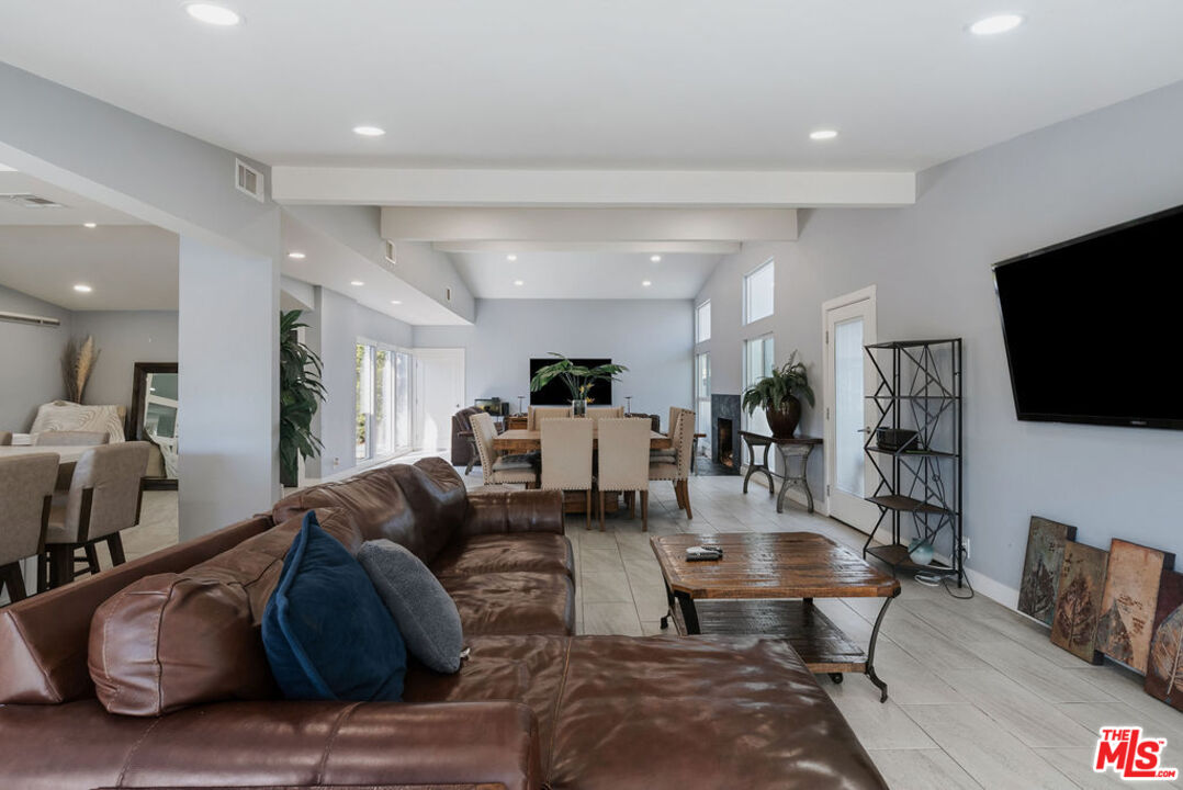 11332 Loch Lomond Road Los Alamitos, CA 90720 - Photo 10 of 55 a living room with furniture and a flat screen tv