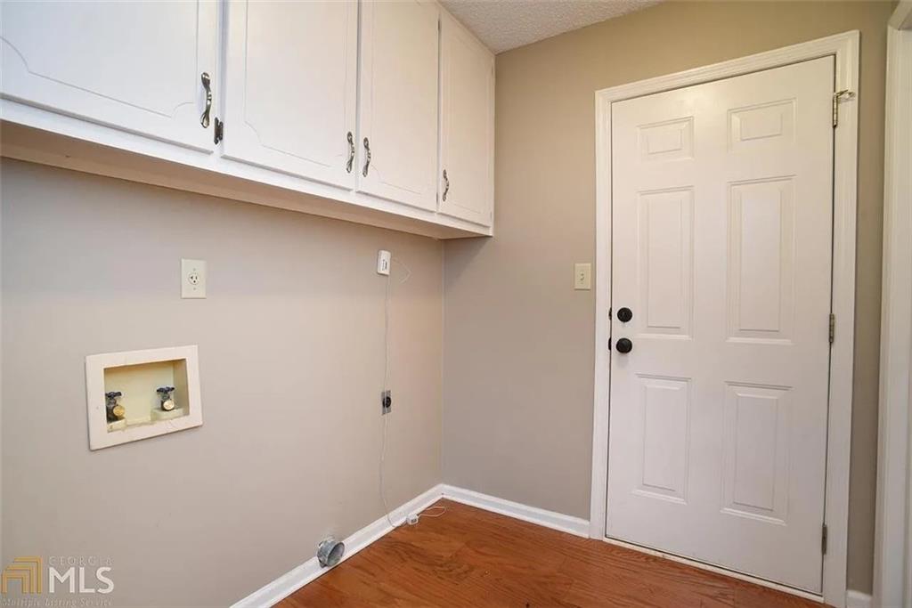 11058 Hunters Lane Hampton, GA 30228 - Photo 13 of 25 a view of cabinets and wooden floor