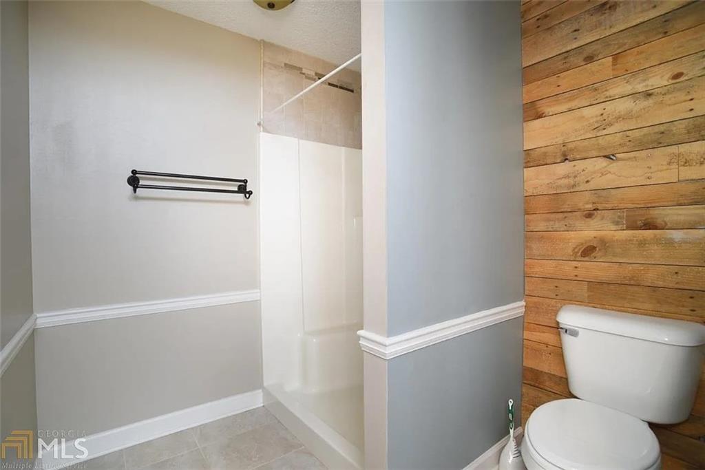 11058 Hunters Lane Hampton, GA 30228 - Photo 15 of 25 a white toilet sitting next to a shower