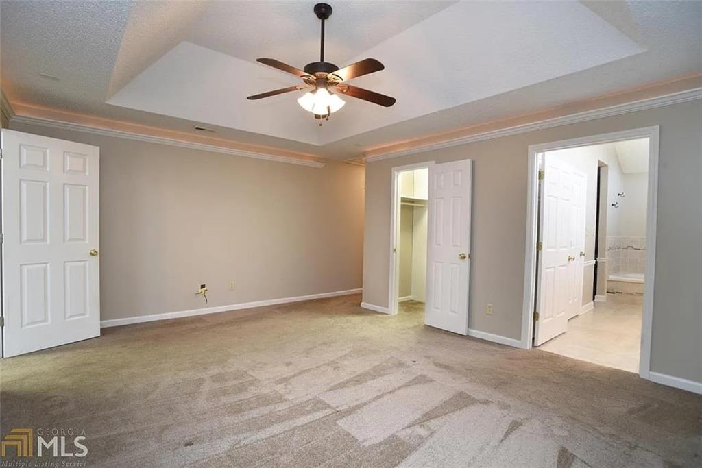 11058 Hunters Lane Hampton, GA 30228 - Photo 16 of 25 a view of an empty room with a chandelier fan