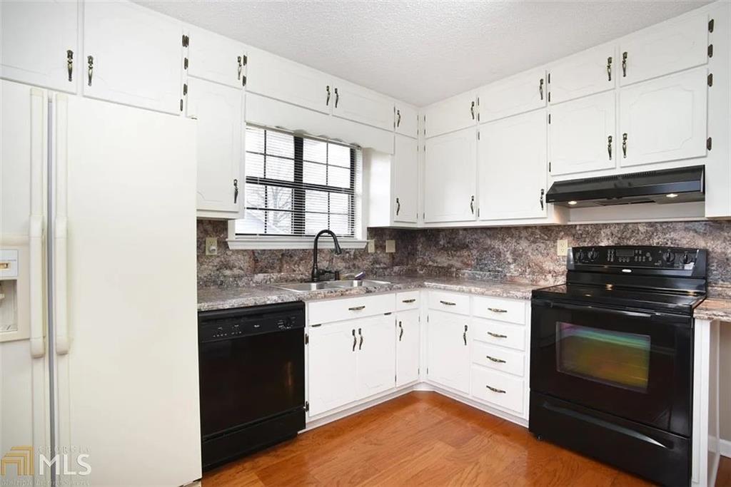 11058 Hunters Lane Hampton, GA 30228 - Photo 18 of 25 a kitchen with stainless steel appliances granite countertop a stove a sink and a refrigerator