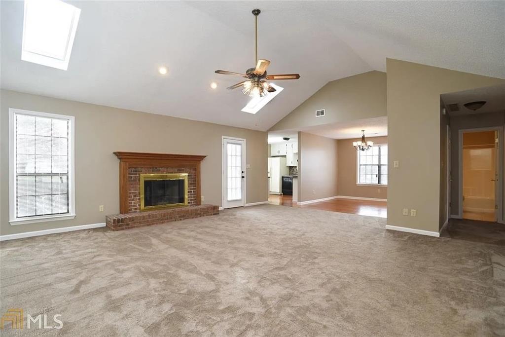 11058 Hunters Lane Hampton, GA 30228 - Photo 2 of 25 a view of an empty room with a fireplace and a window