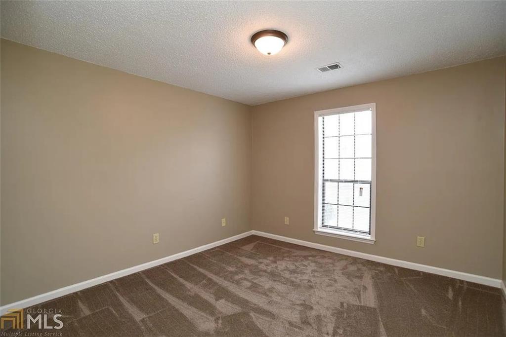 11058 Hunters Lane Hampton, GA 30228 - Photo 22 of 25 an empty room with a window