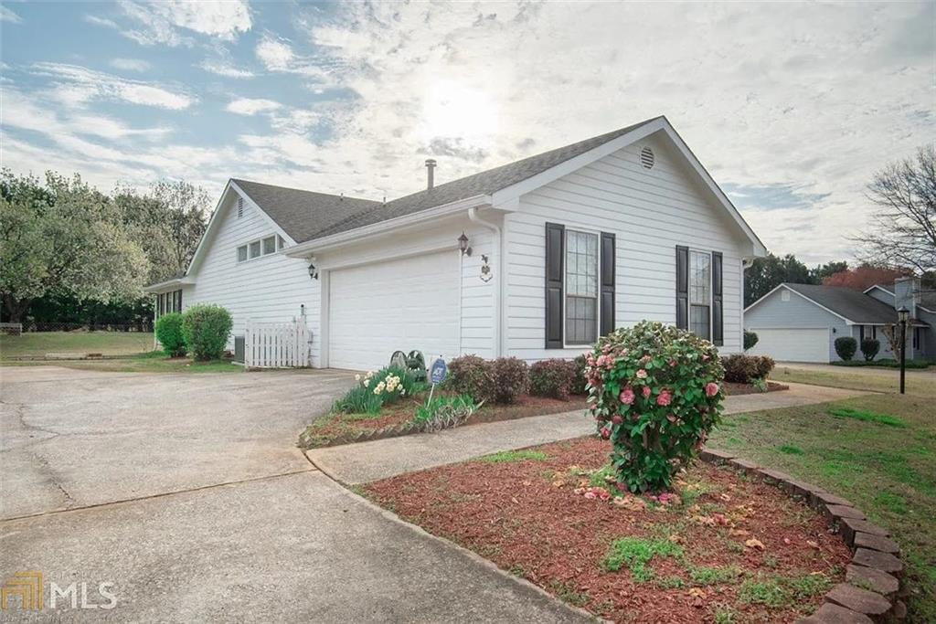 11058 Hunters Lane Hampton, GA 30228 - Photo 25 of 25 a view of a house with a yard and a garden