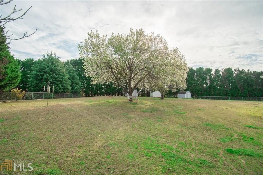 11058 Hunters Lane Hampton, GA 30228 - Photo 4 of 25 a view of field with trees in the background